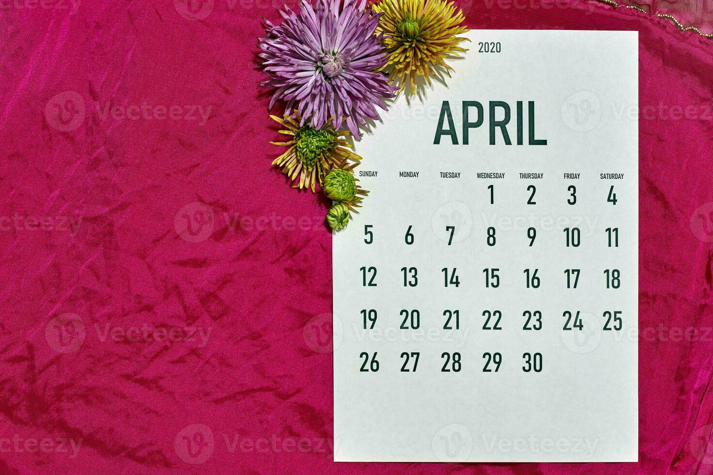 April monthly calendar on red photo