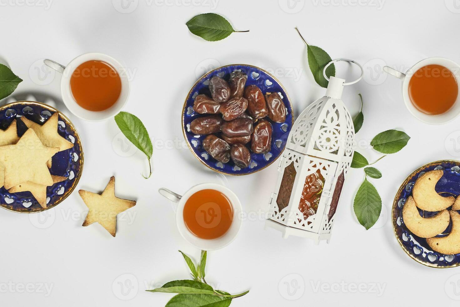 Iftar foods on white table. Traditional middle-eastern lunch with cookies and sweets photo