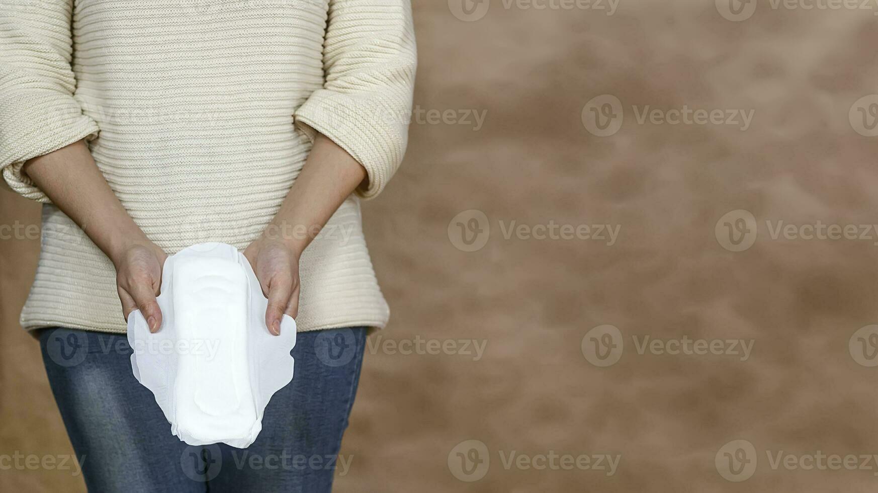 Young woman holding a menstrual pad photo