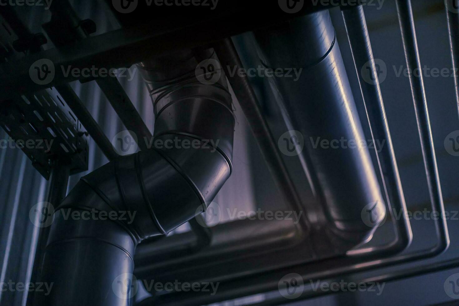 Equipment and piping inside of industrial plant. Factory. Various mechanisms and metal pipes. Toned image. photo