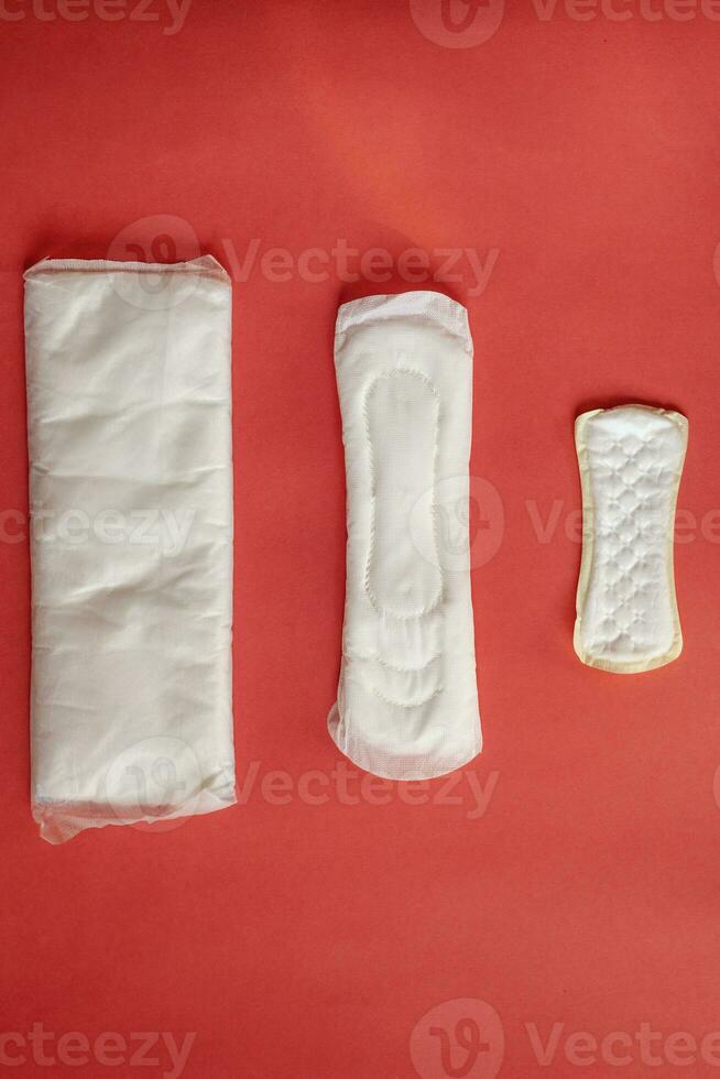Feminine hygiene pads on red background photo