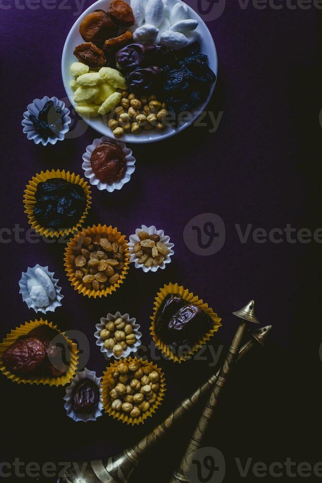 Eid Mubarak. Different iftar sweets. Celebrating Eid Al Adha. Islamic traditional holiday. Eid al-Fitr. Holly month Ramadan. Middle Eastern religious holiday. Dried date fruit. Flat lay, top view. photo