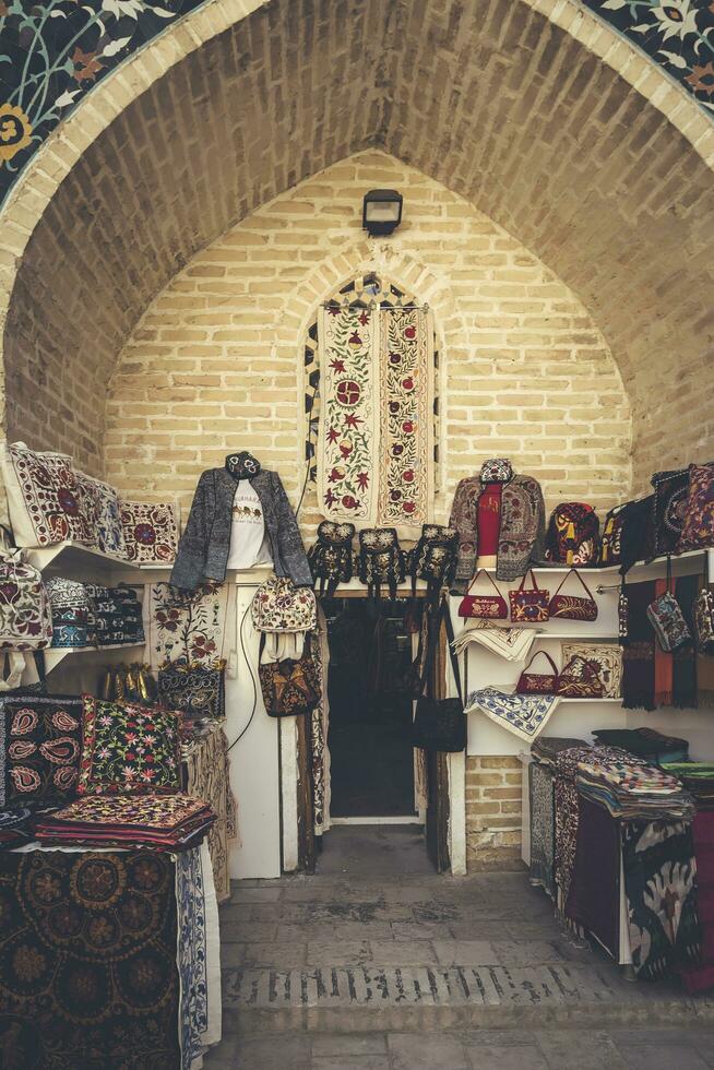 Bukhara, Uzbekistan - March 13, 2019 Outdoor street shops inside of Nadir Divan-Begi Madrasah photo