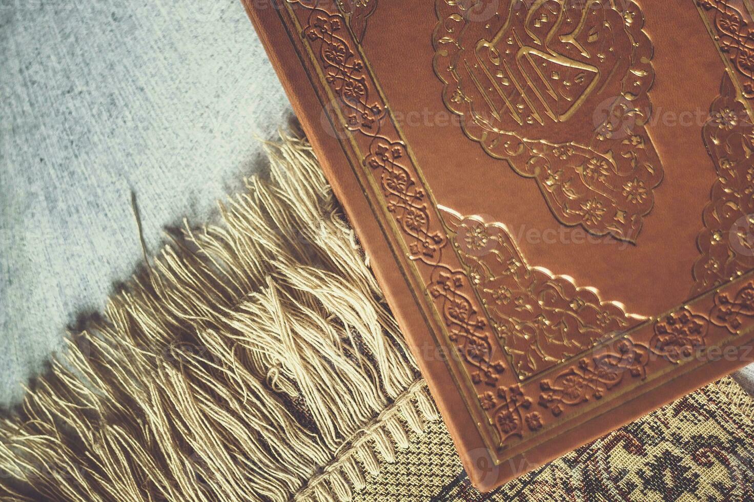The Holy Quran on praying carpet. Flat lay view photo