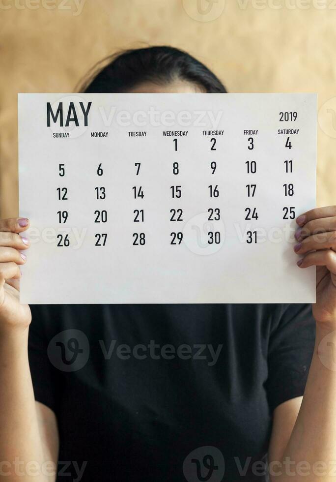 Woman holding Monthly calendar of May, 2019 photo