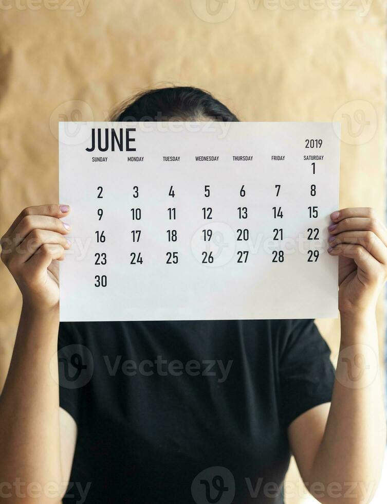 A woman holding simple june 2019 calendar photo