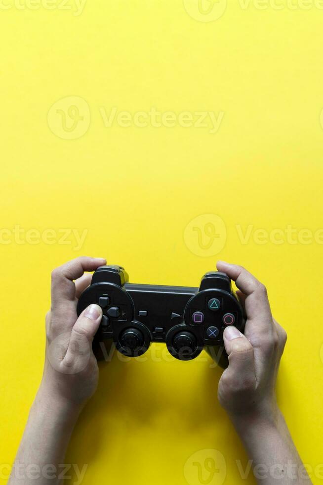 Vertical view of hands with gamepad photo