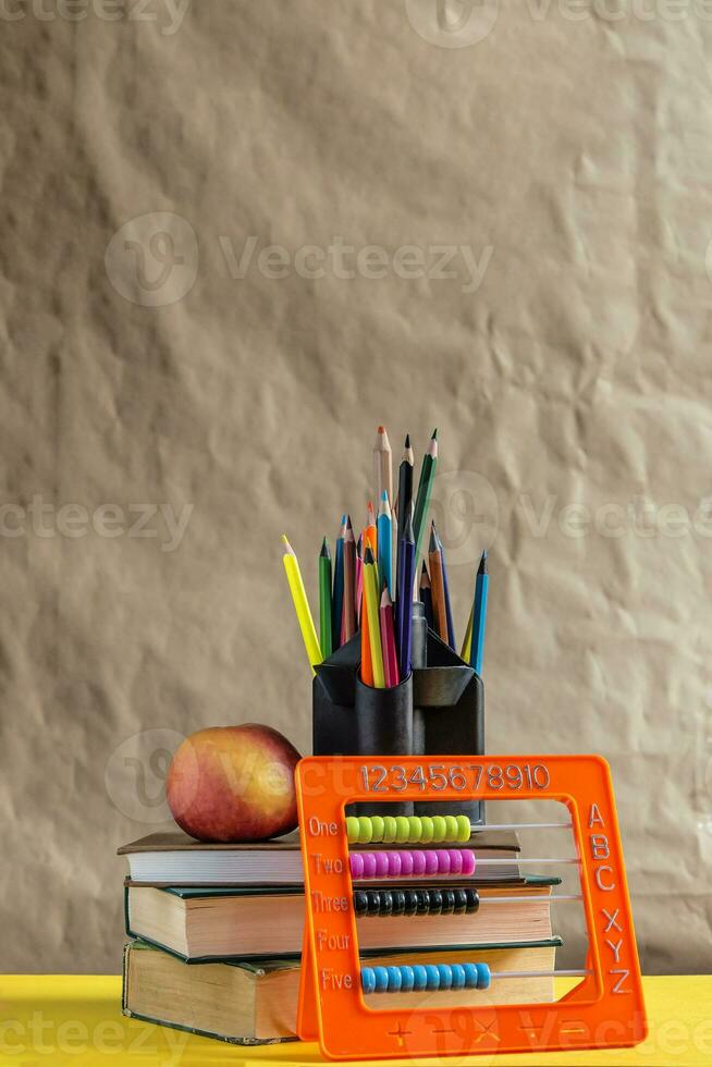 Back to school concept. Stack of books with school supplies photo