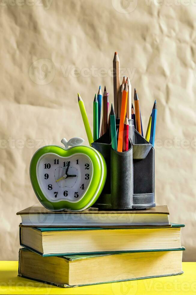 Back to school concept. Stack of books with school supplies photo