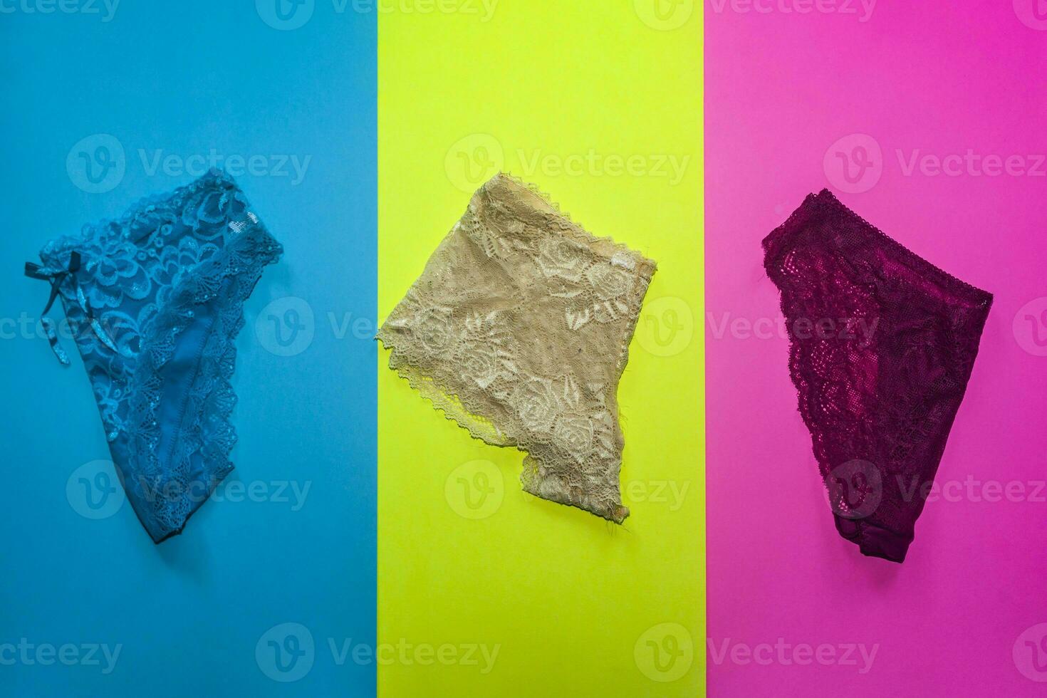 Three women panties on different colored backgrounds. Women underwears photo