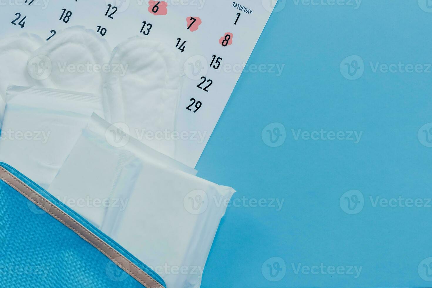 Monthly calendar and sanitary pads. Menstruation cycle calendar. Women health concept. Period days concept showing feminine menstrual cycle. photo