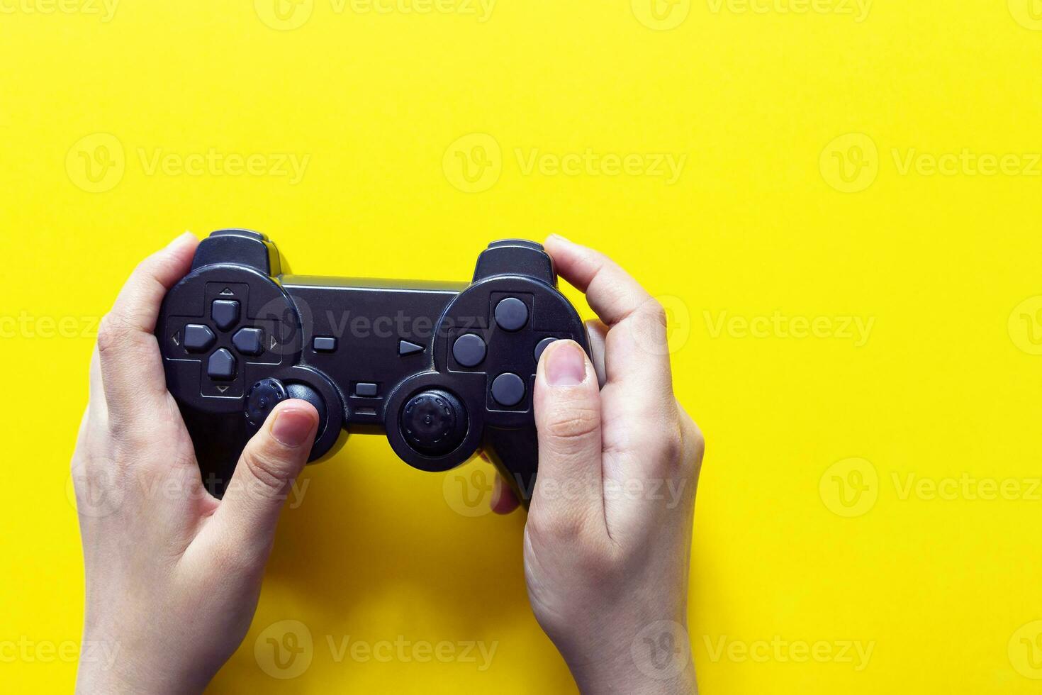 Vertical view of hands with gamepad photo