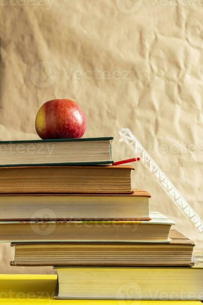 Back to school concept. Stack of books and apple. photo