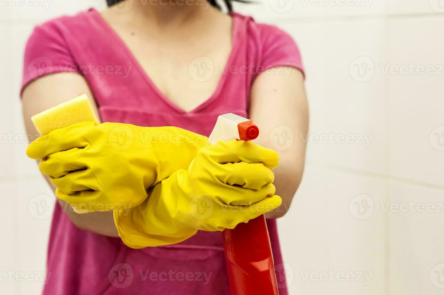 Young woman equipped with spray bottle and sponge. Housekeeping and cleaning concept. Women preparing to clean up bath photo