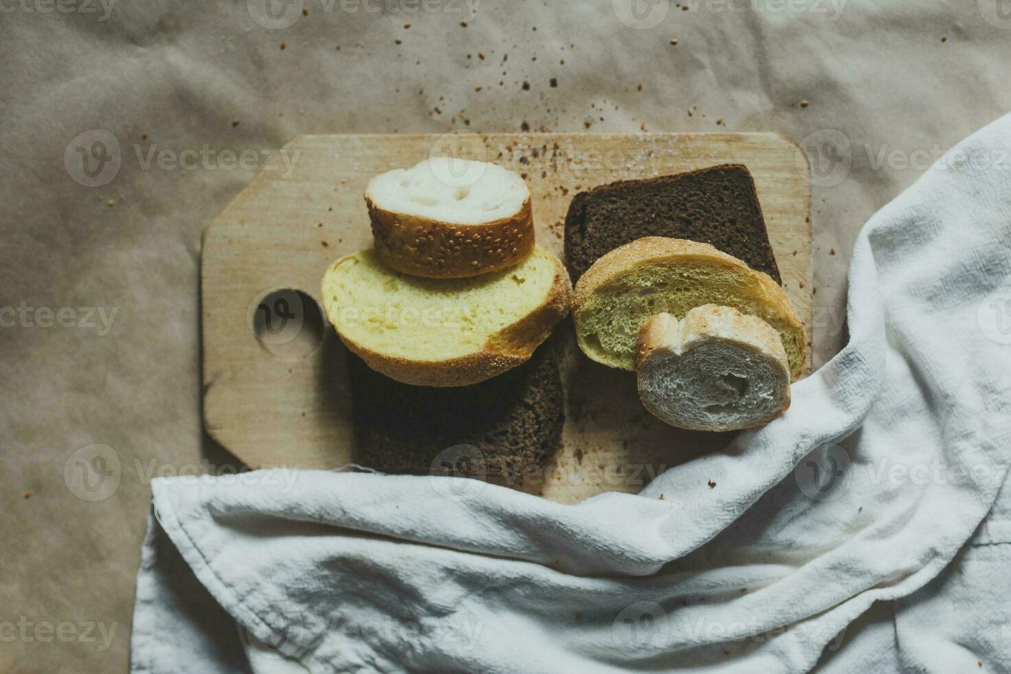 Food concept. Hand cutting bread. Slicing a bread. Top view. photo