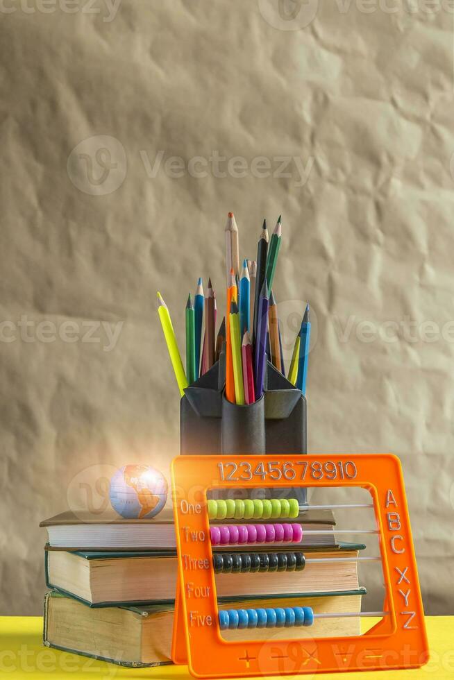 Back to school concept. Stack of books with school supplies photo