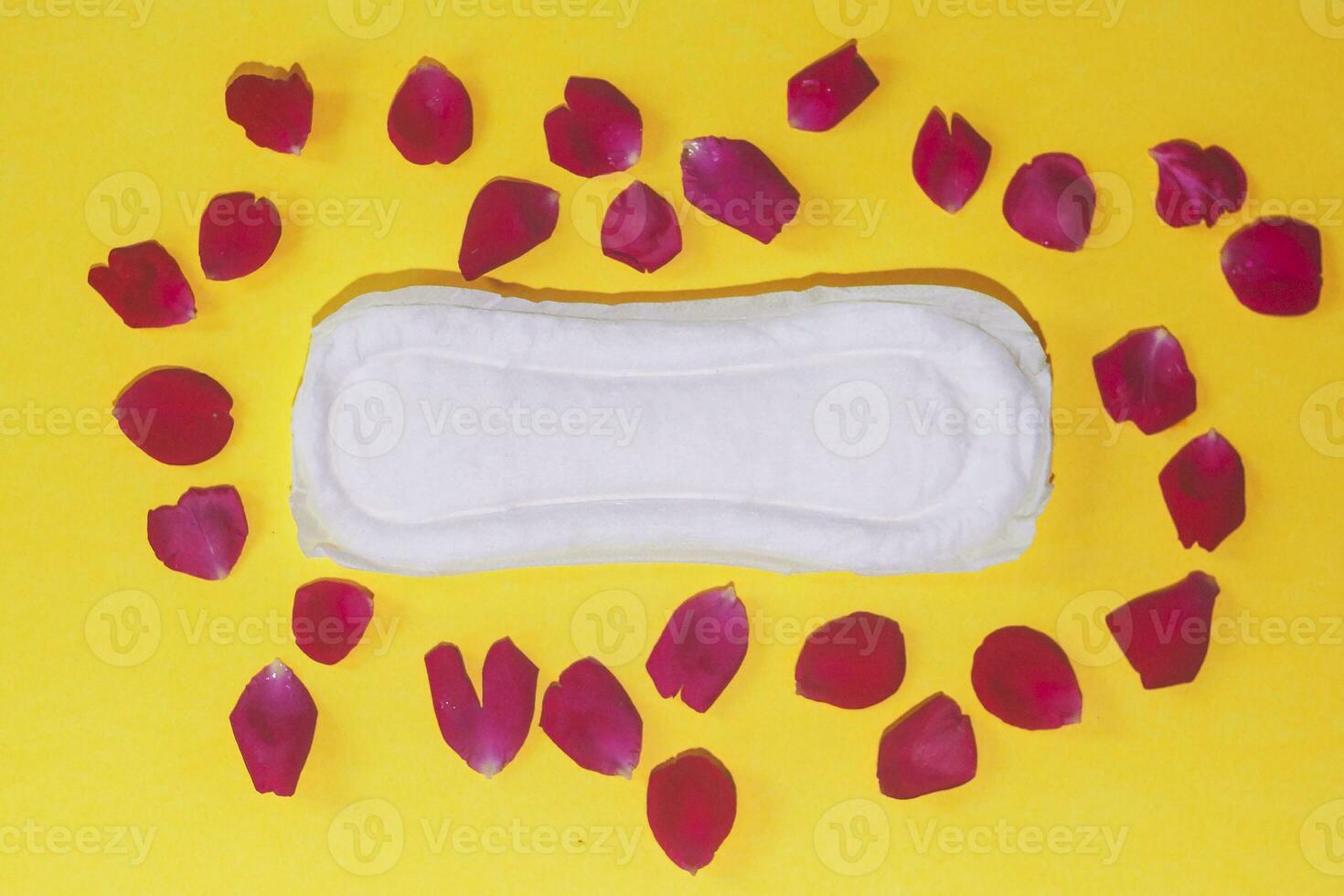 Female's hygiene products on yellow background. Concept of critical days, menstrual cycle, period days, PMS photo