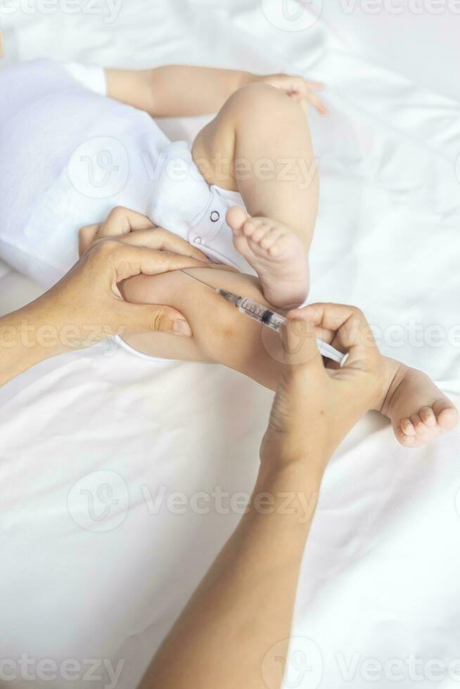 Doctor vaccinating a newborn baby boy. Child's Immunization, Children's Vaccination, Health concept. photo