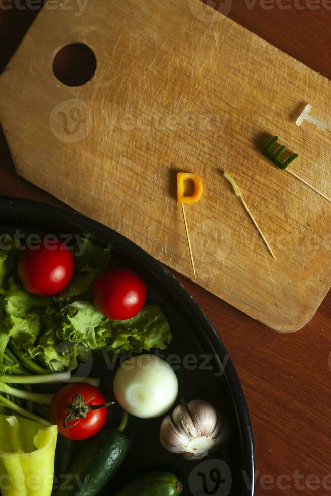 Diet word made cut from vegetables and dish of fresh vegetables. Healthy food concept photo