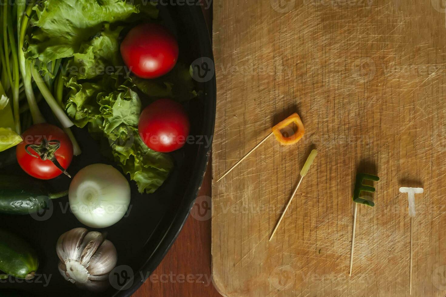 Diet word made cut from vegetables and dish of fresh vegetables. Healthy food concept photo