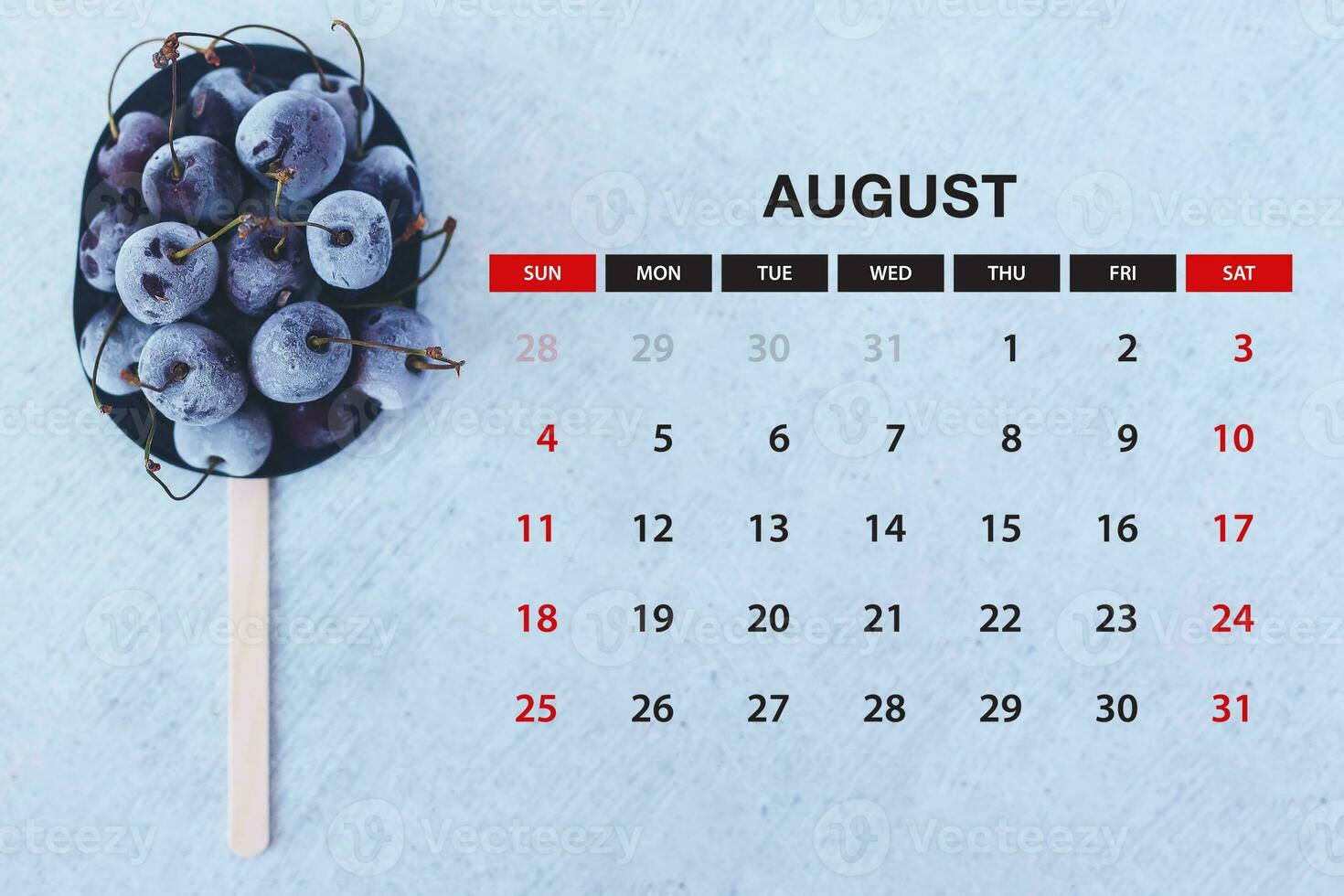 August calendar. Stack of frozen sweet cherries with August month calendar. Summer photo