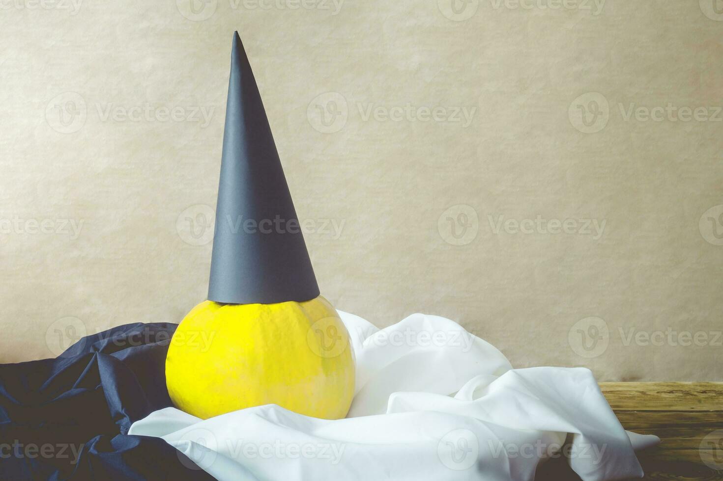 Halloween pumpkin with black paper hat photo