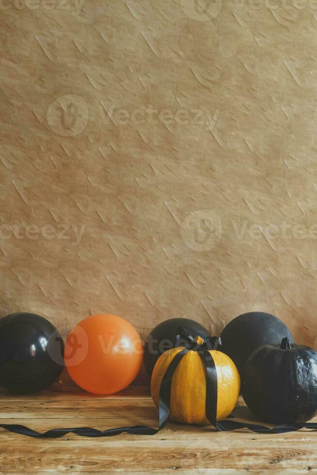 Halloween pumpkin and air balloons on the table photo