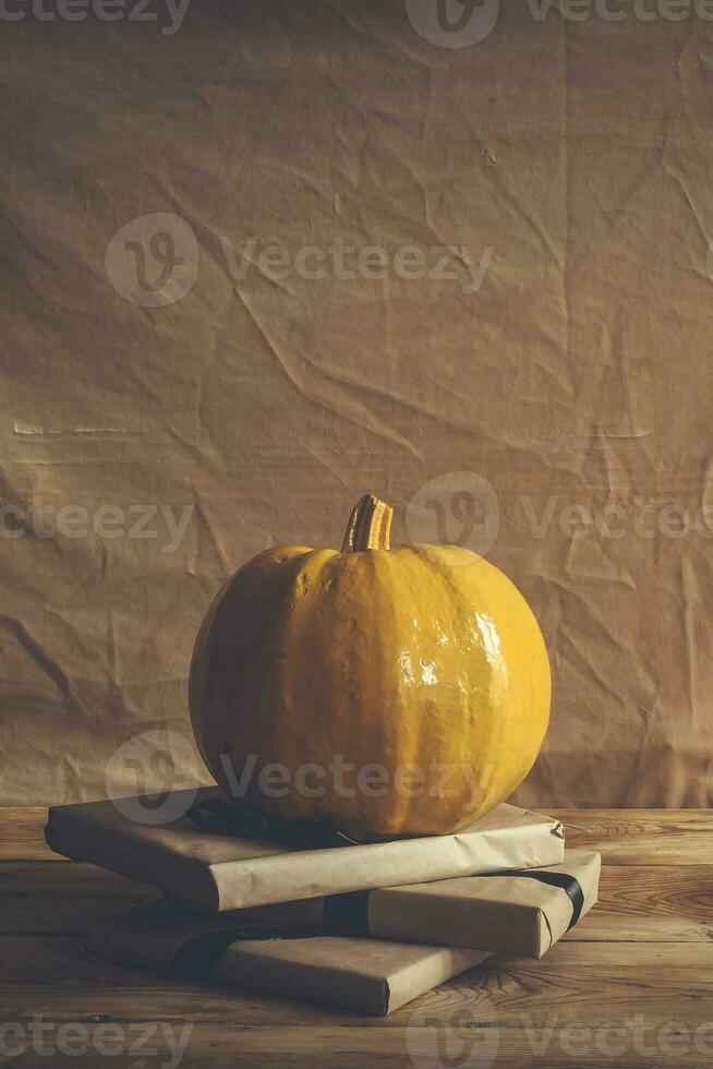 Celebrating Halloween. Orange and black pumpkins with decorated gift boxes photo