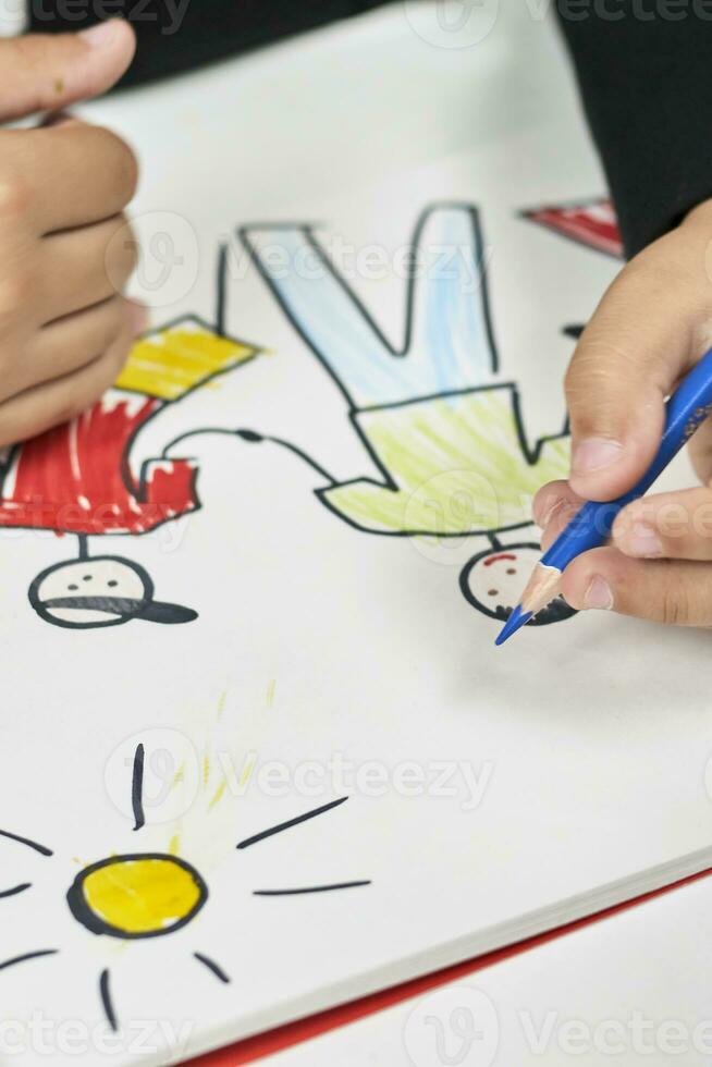Family therapy. Schoolboy drawing family. Painting with colored marker photo