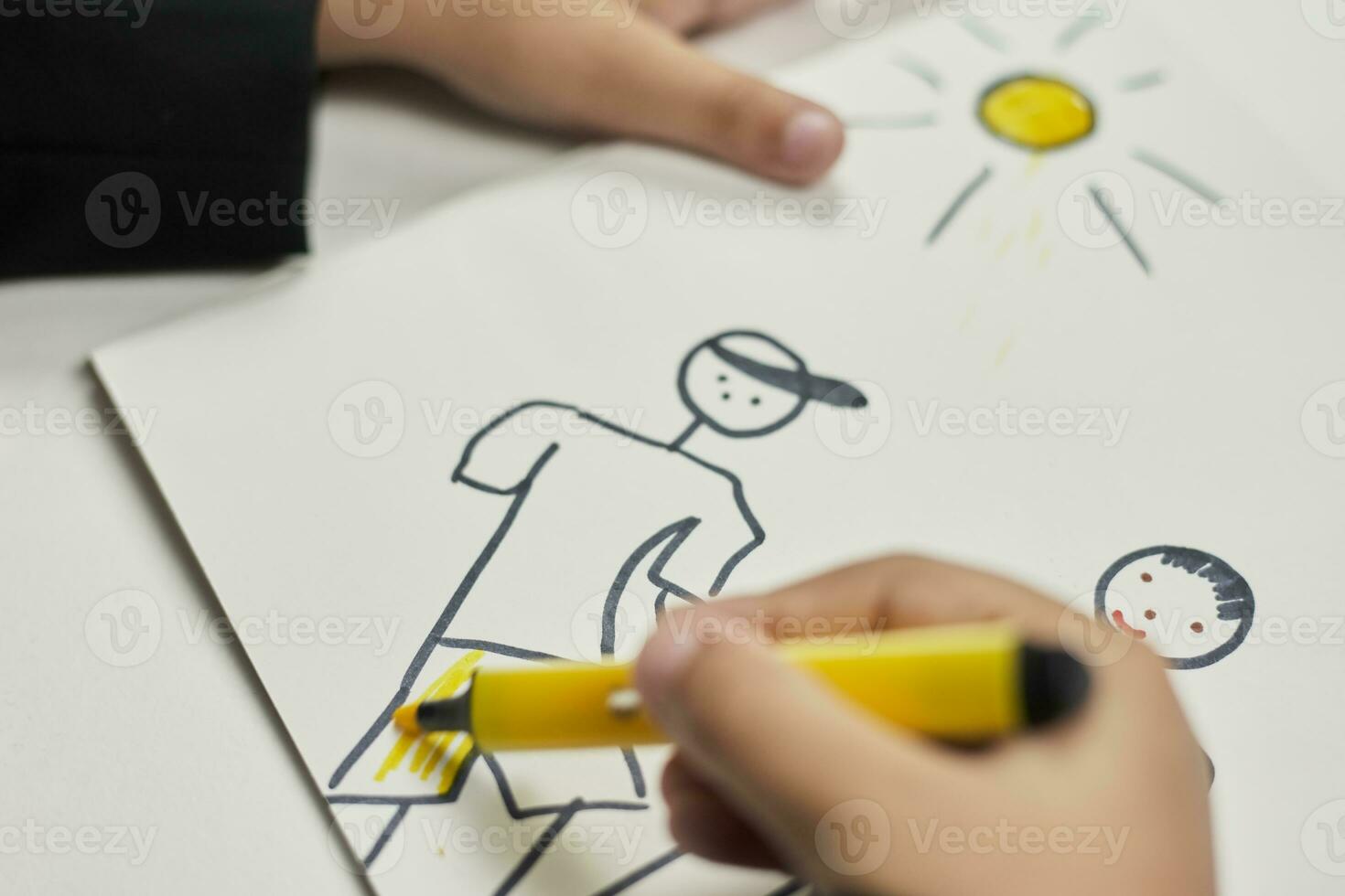 Family therapy. Schoolboy drawing family. Painting with colored marker photo