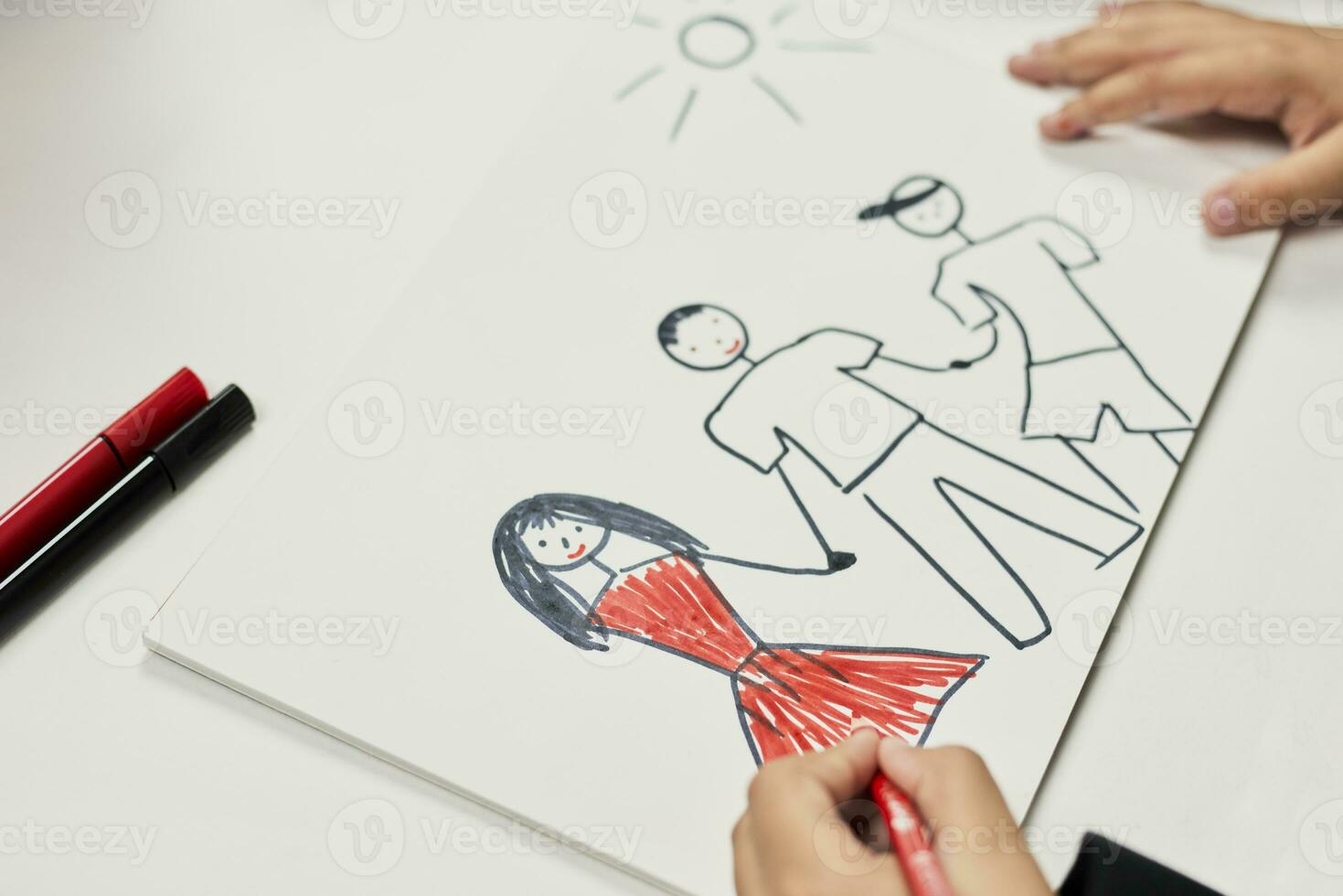 Family therapy. Schoolboy drawing family. Painting with colored marker photo