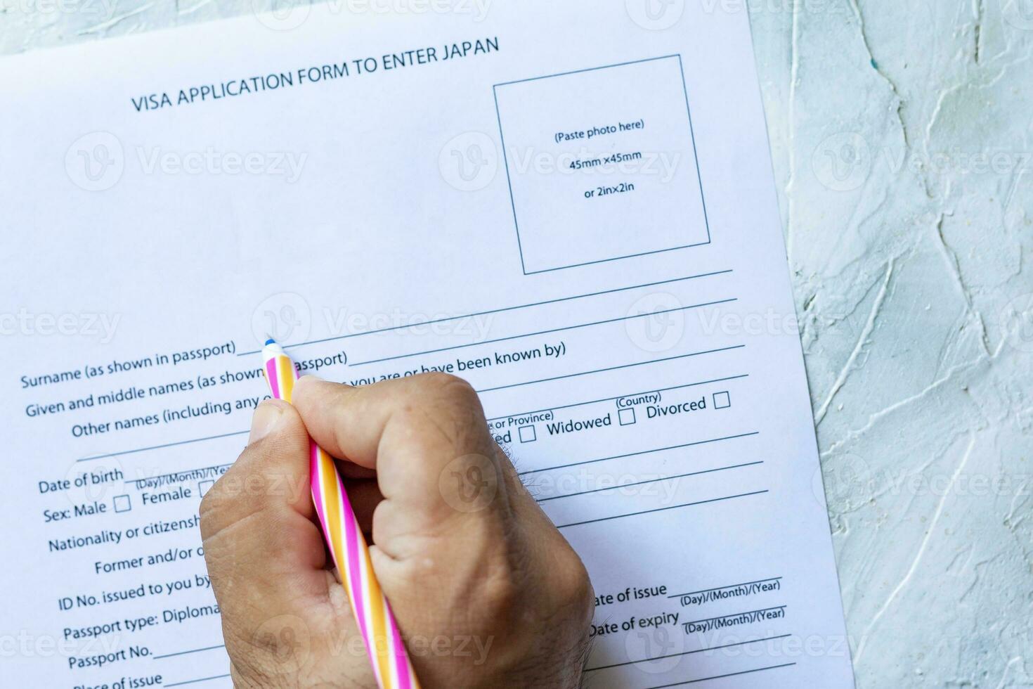 Hand filling Japan Visa Application Form photo