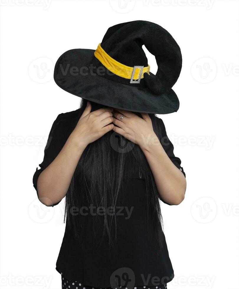 Portrait of young woman in witch costume isolated on white background. Halloween theme on white photo