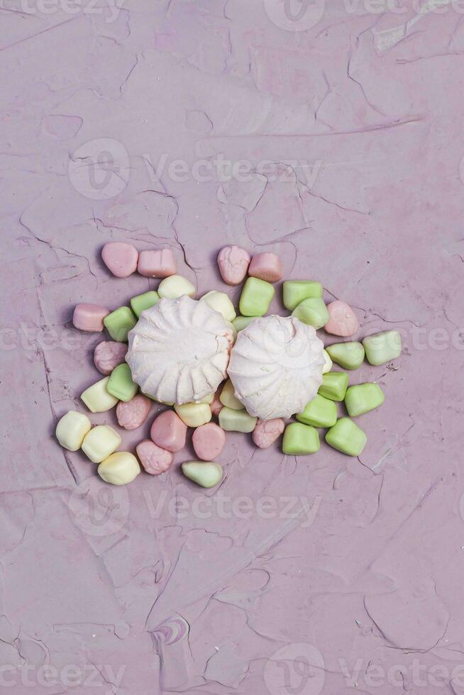 Marshmallows on pink background. Colorful marshmallow sweets with copy space photo