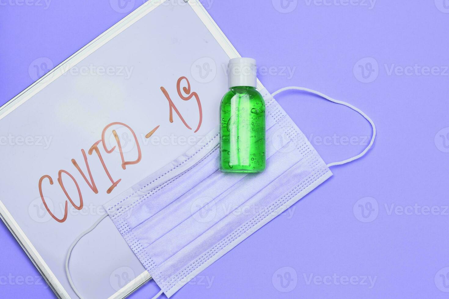 Antiseptic gel and face mask with covid-19 inscription photo