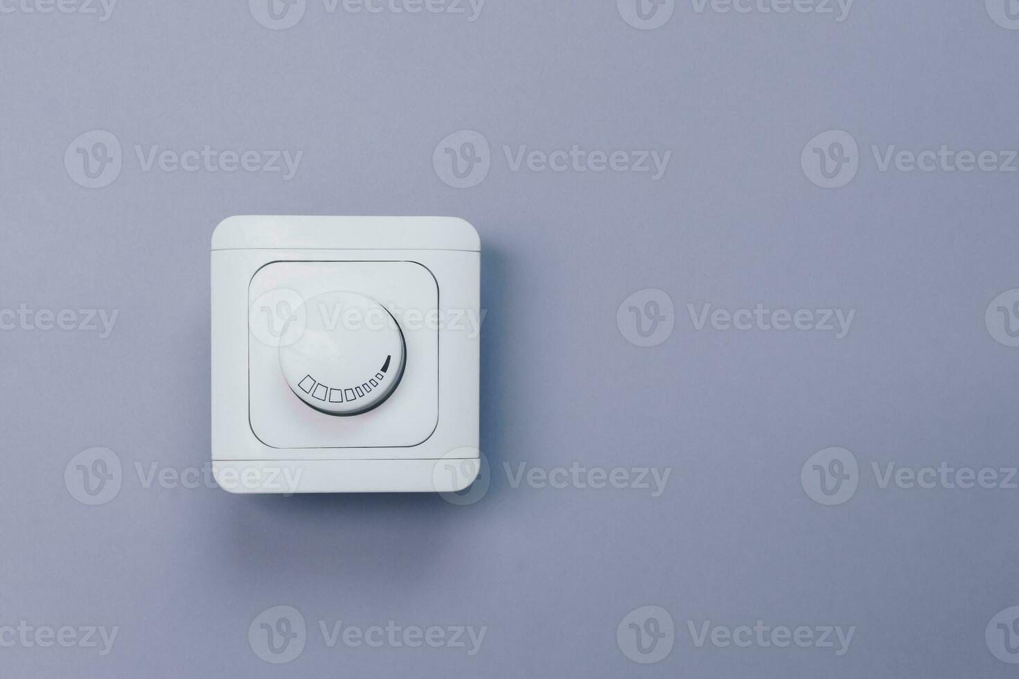 Dimmer Light Switch. A wall switch. Electrician switch. White rolling electricity switch photo