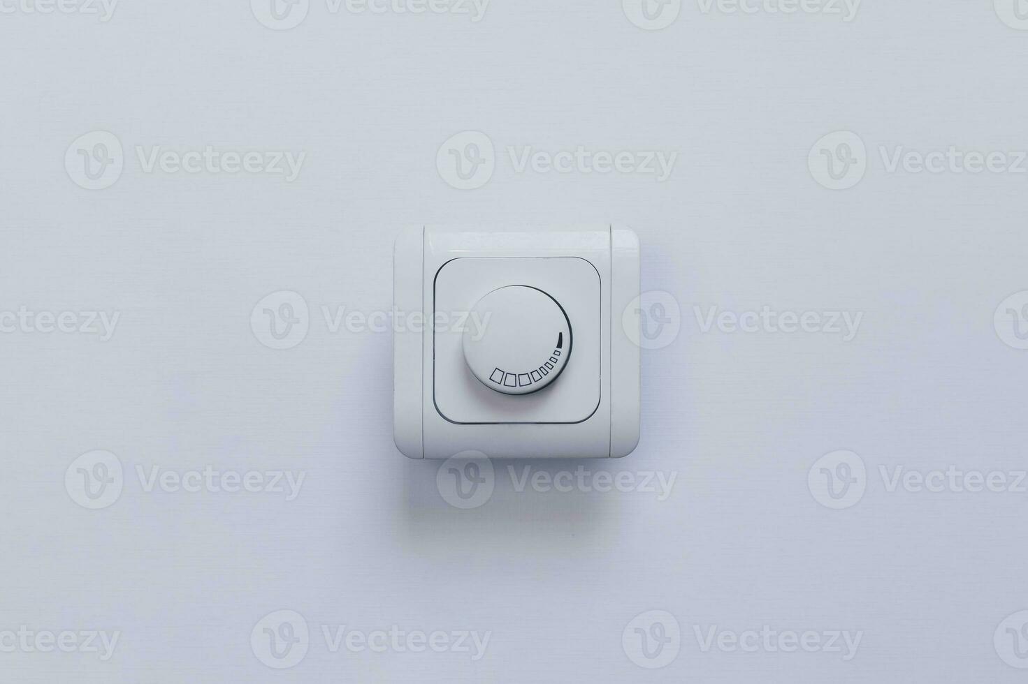 Dimmer Light Switch. A wall switch. Electrician switch. White rolling electricity switch photo
