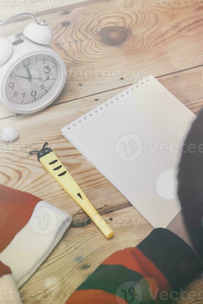 Little boy writing to Santa Claus. A kid writes a letter to Santa Claus. Child thinking, dreaming about Christmas wish photo