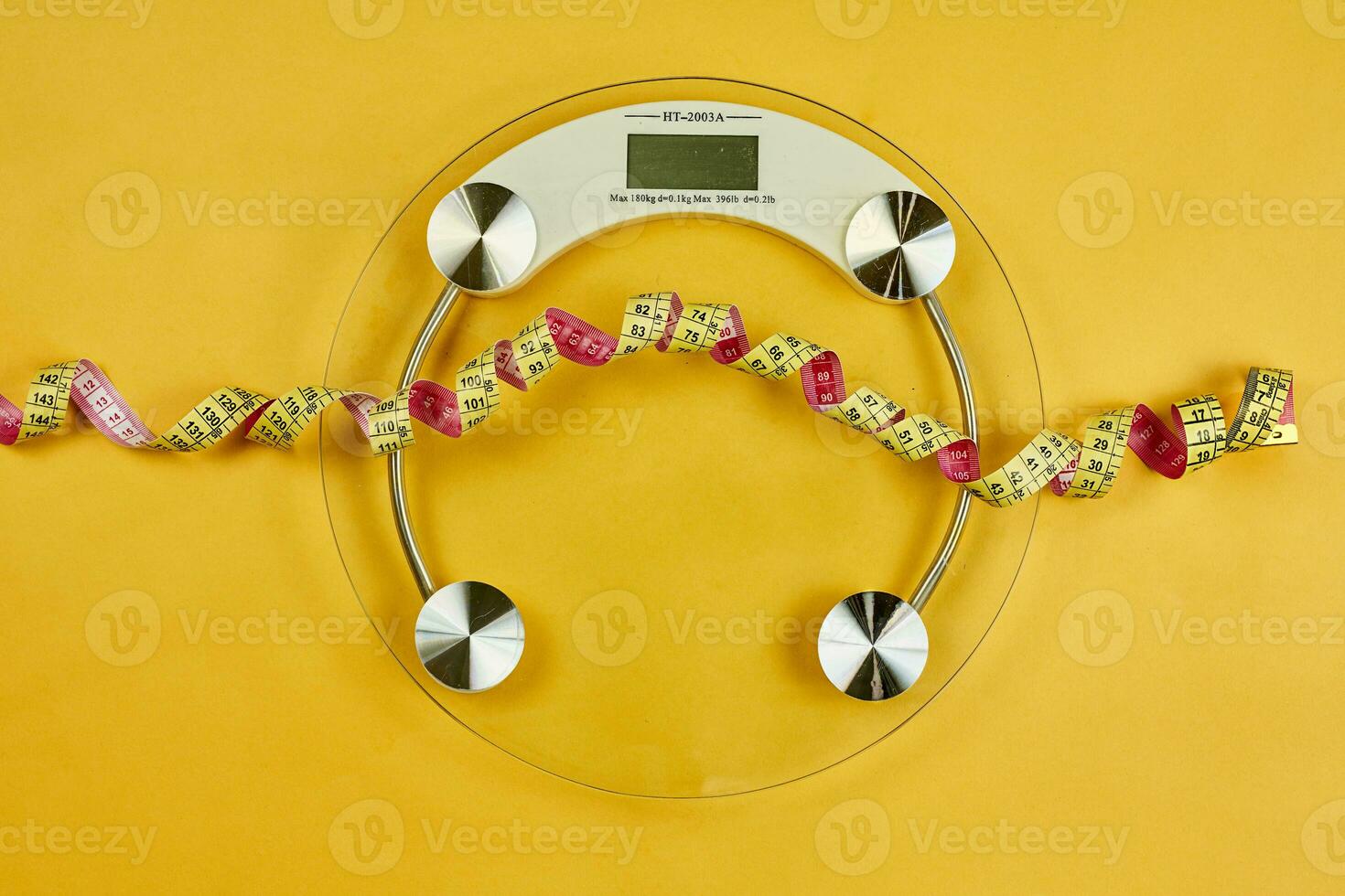 Bathroom scale and measuring tape photo