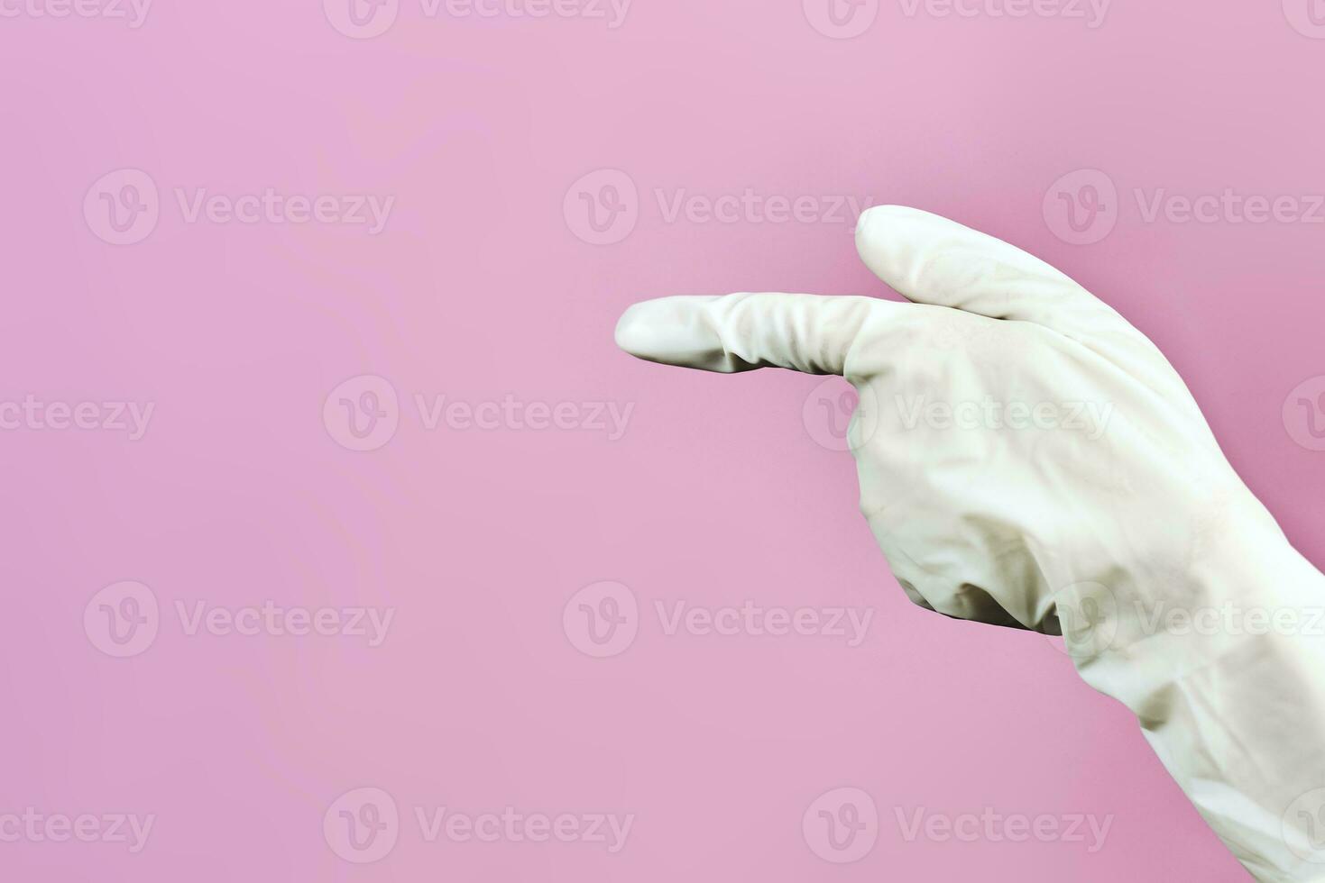 Female doctor hands in surgical gloves showing to left side with hand gesture photo