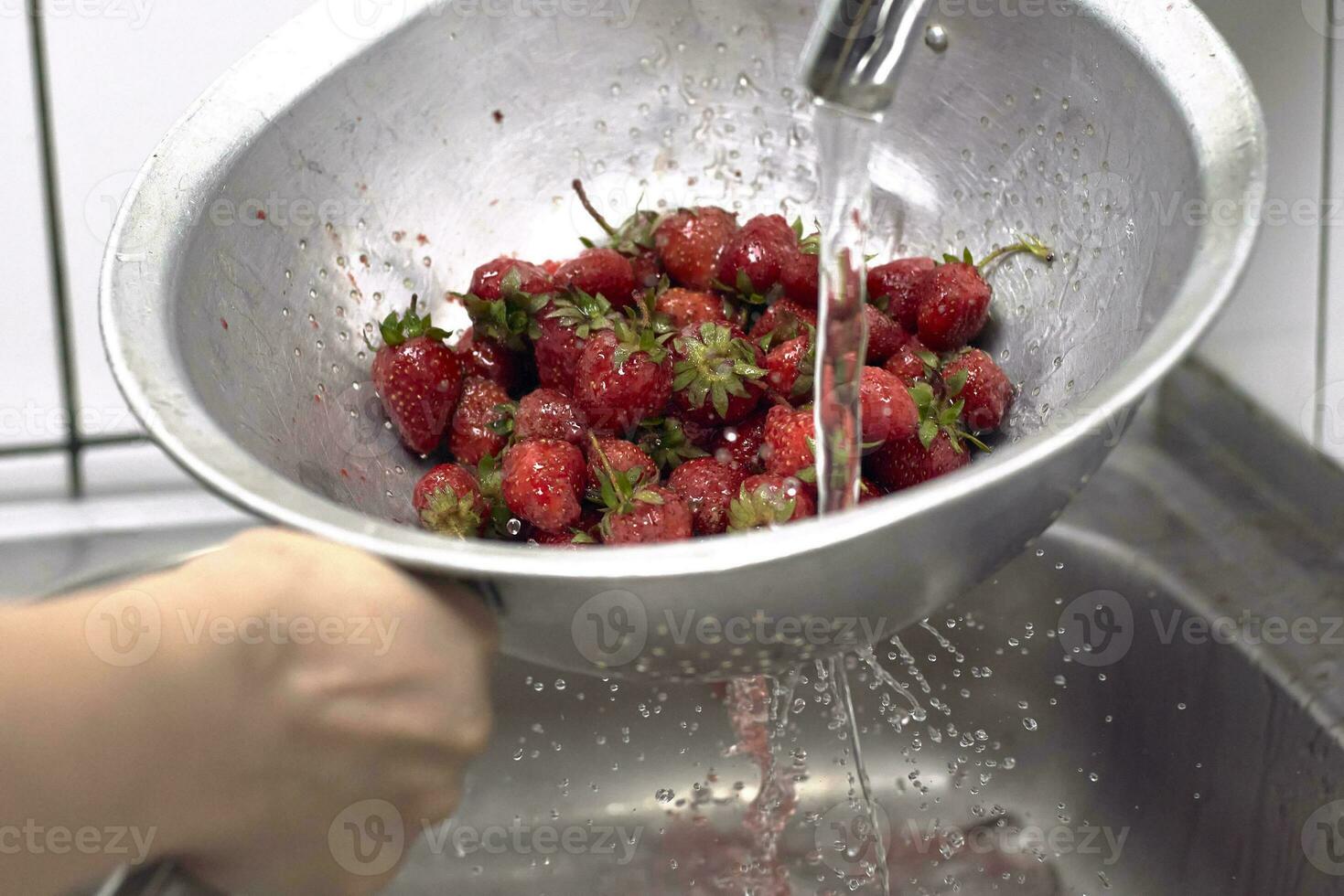 Washing fresh raw strawberries photo