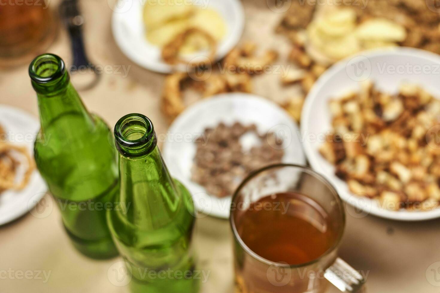 Drinking beer. Table full of beer snacks photo