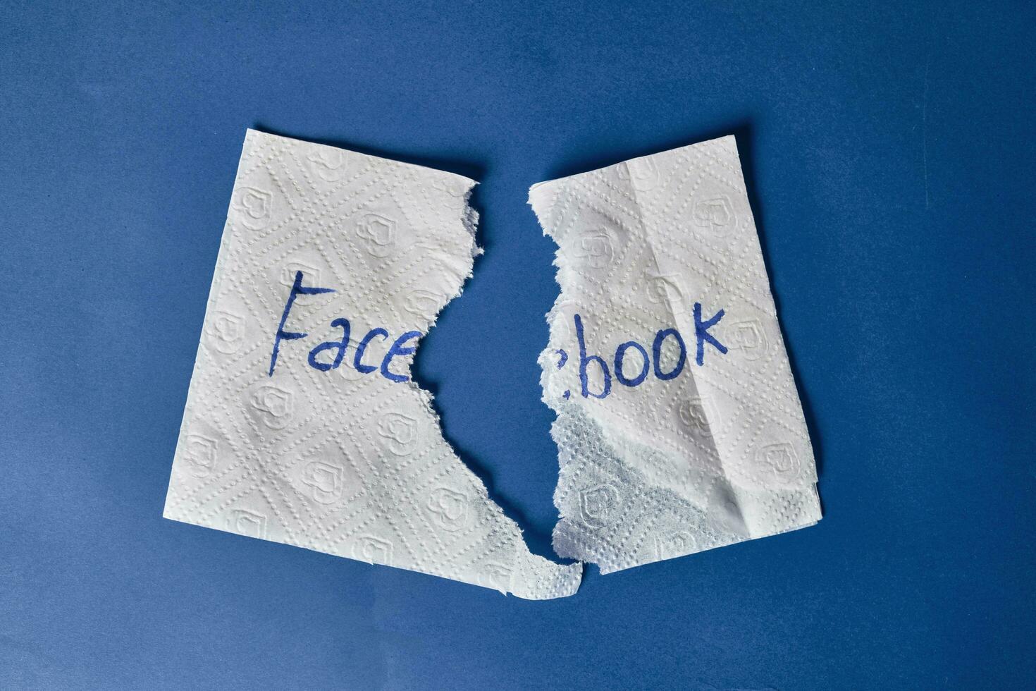 Facebook logo on torn paper napkin photo