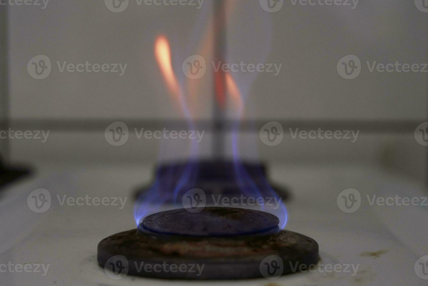Burning flame on gas stove burner photo