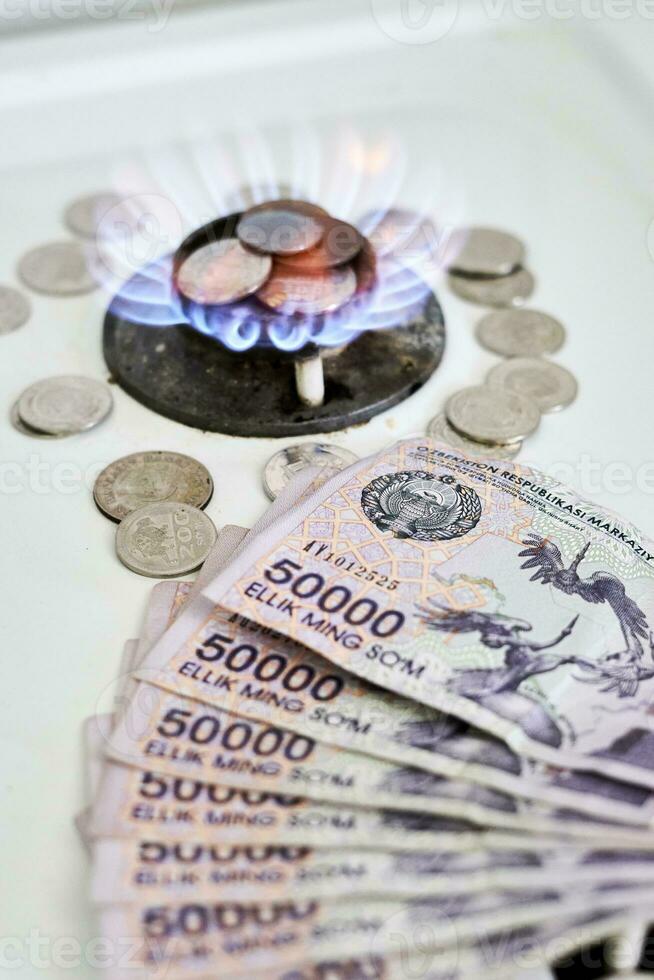 Burning gas stove burner and money photo