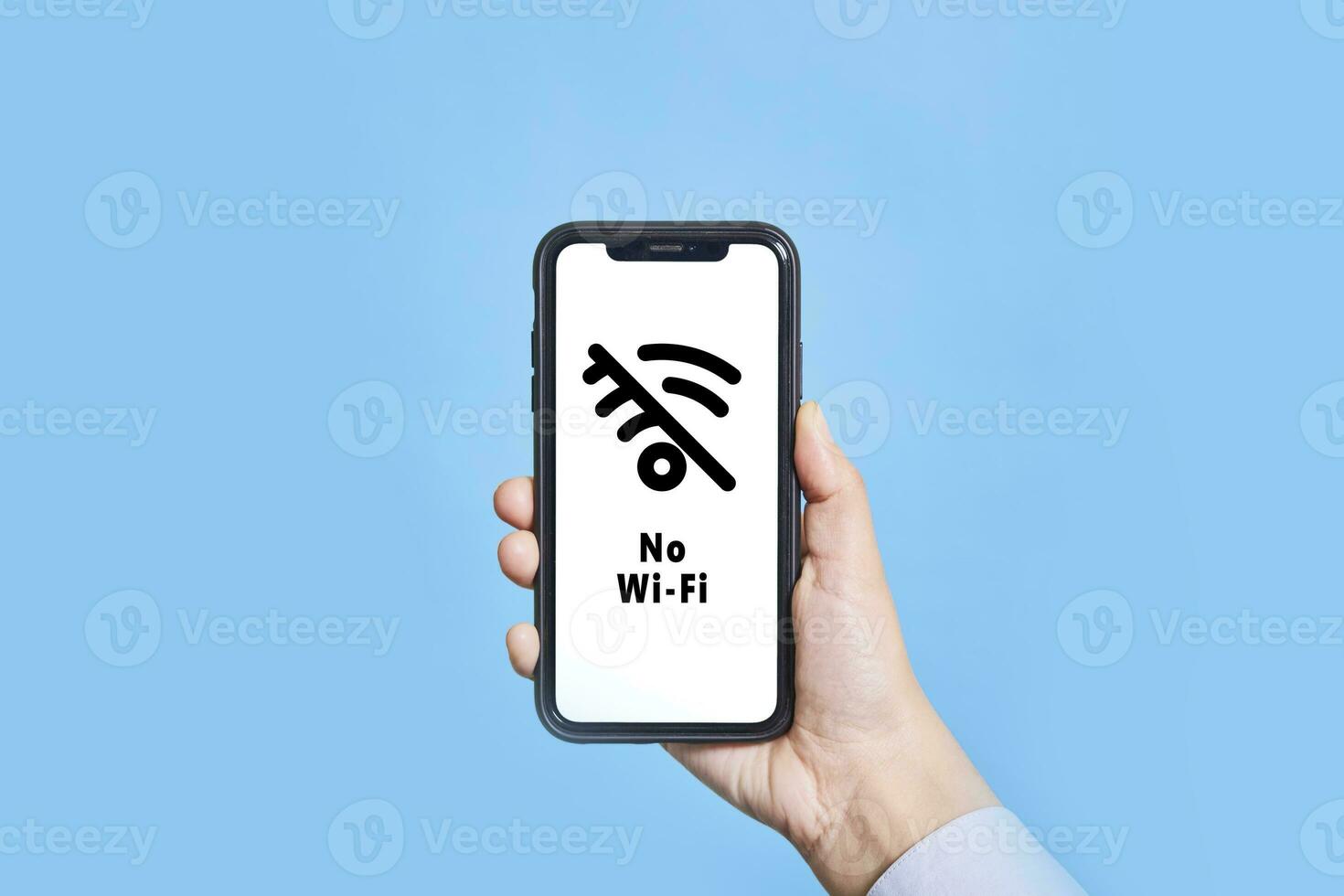 A person holds mobile phone with No-Wifi symbol on screen photo