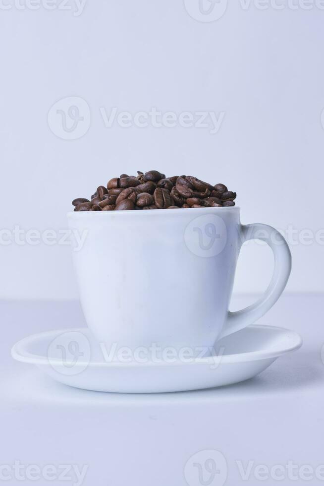 A cup filled with raw coffee beans photo