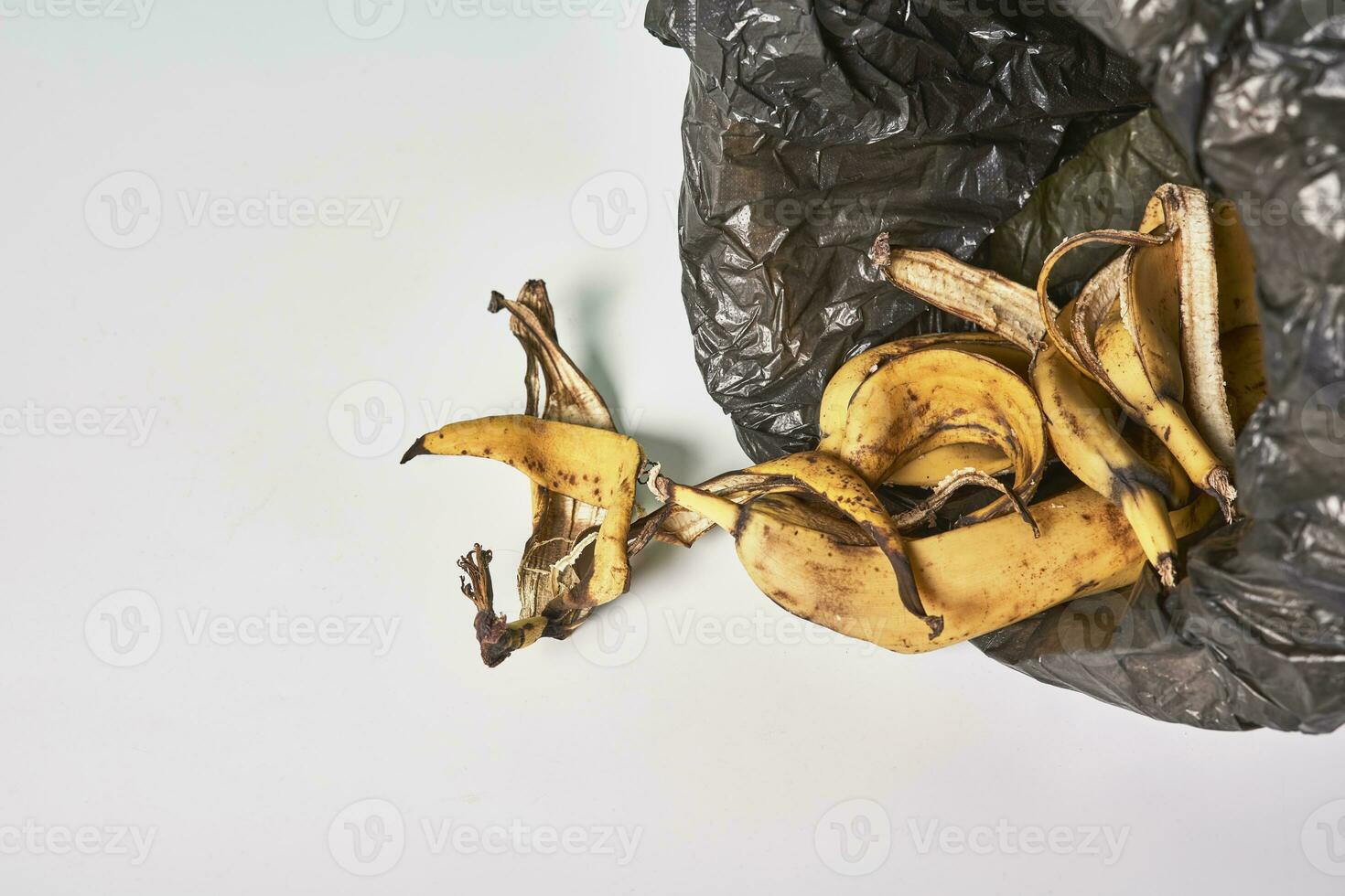 Banana peels in trash can photo