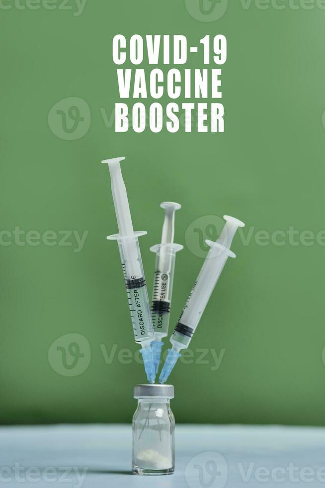 A covid-19 vaccine vial with syringes photo