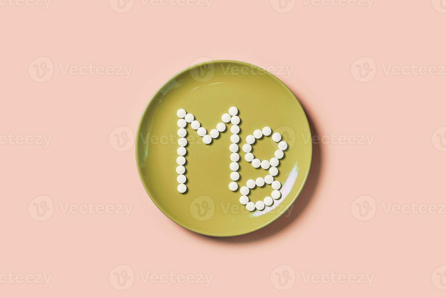 MG text. Symbol of magnesium on plate photo